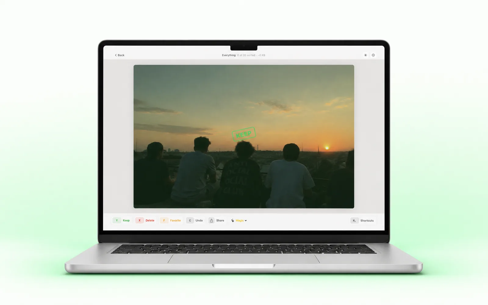 SwipePhotos for Mac reviewing a sunset photo with the KEEP stamp and keyboard action bar on a MacBook